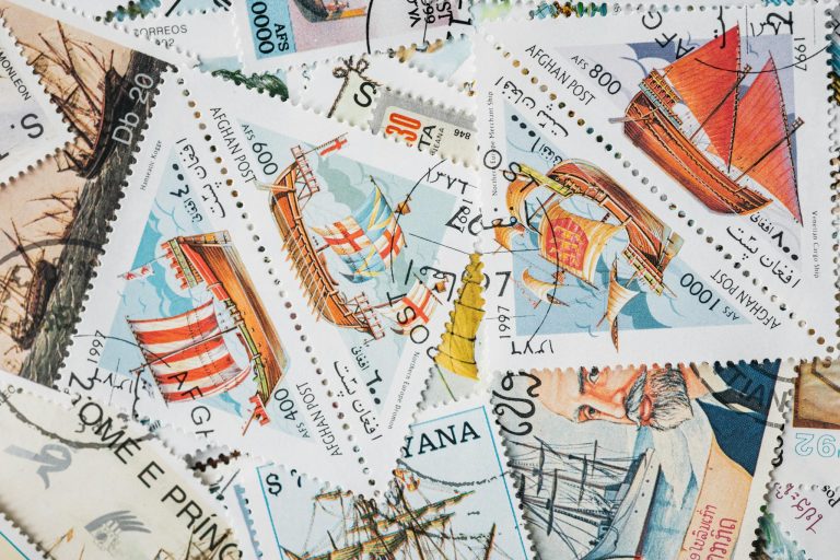A vibrant assortment of vintage postage stamps featuring historical ships, perfect for collectors.
