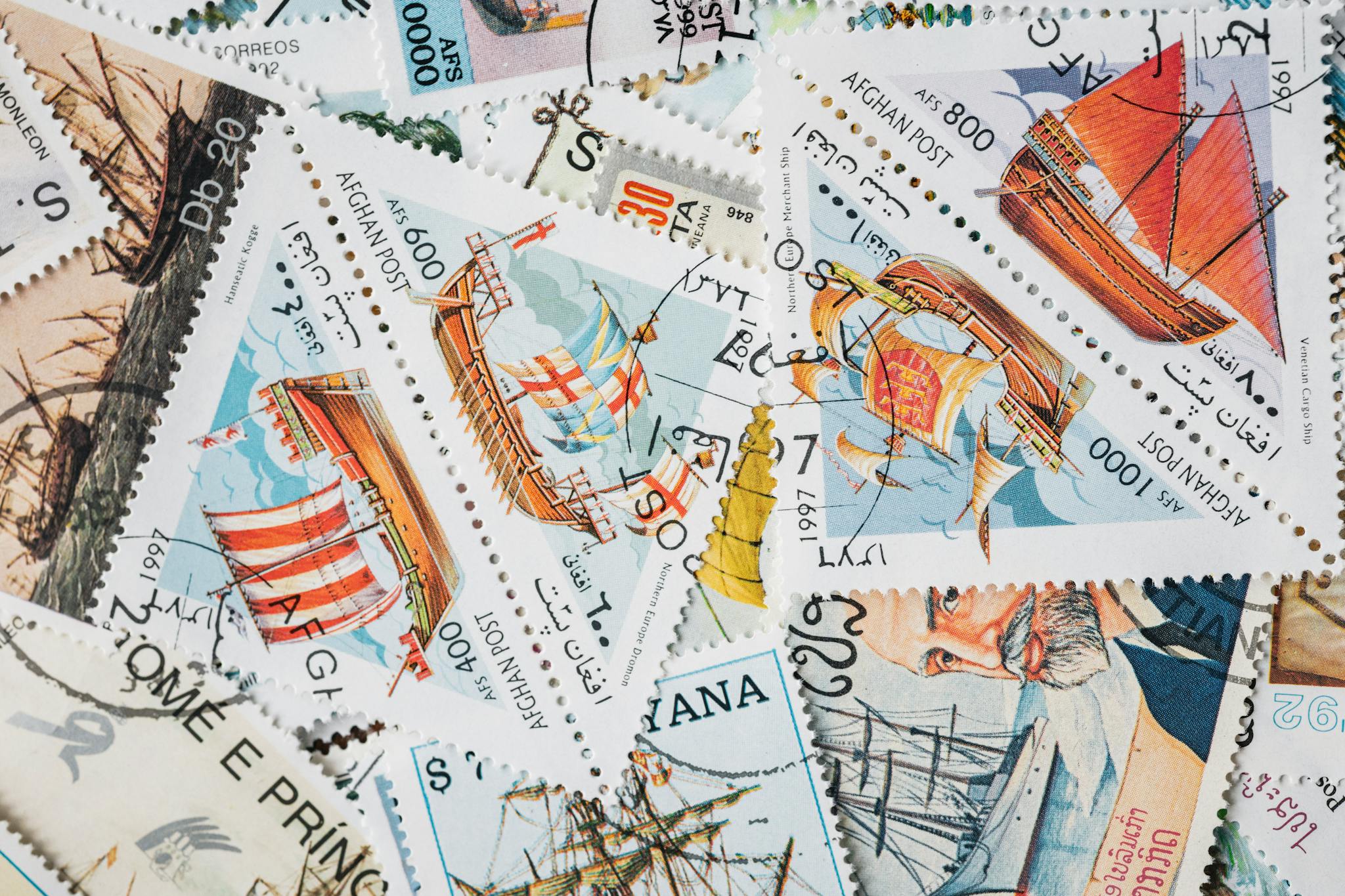 A vibrant assortment of vintage postage stamps featuring historical ships, perfect for collectors.